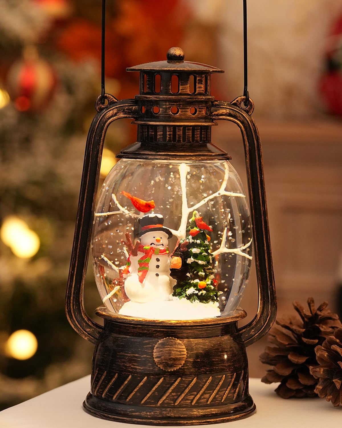 EDDORUNNING snow globe front view showing snowman scene and warm glow benefit