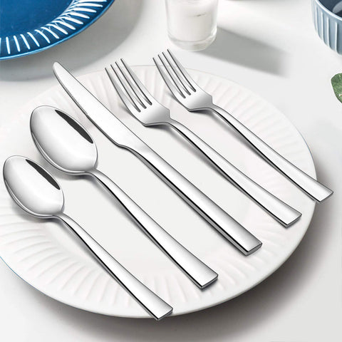 E-far spoons held in hand to show size and comfortable weight