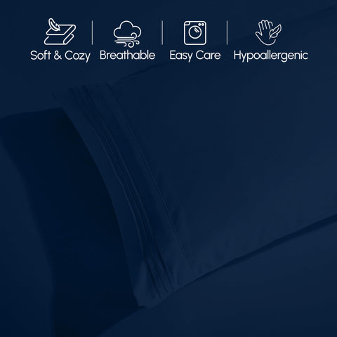 Elegant Comfort made bed in a modern bedroom showing navy sheets and styled look