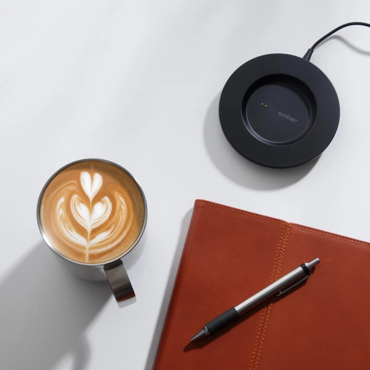 Ember mug 2 on a desk next to laptop showing consistent hot drink during work