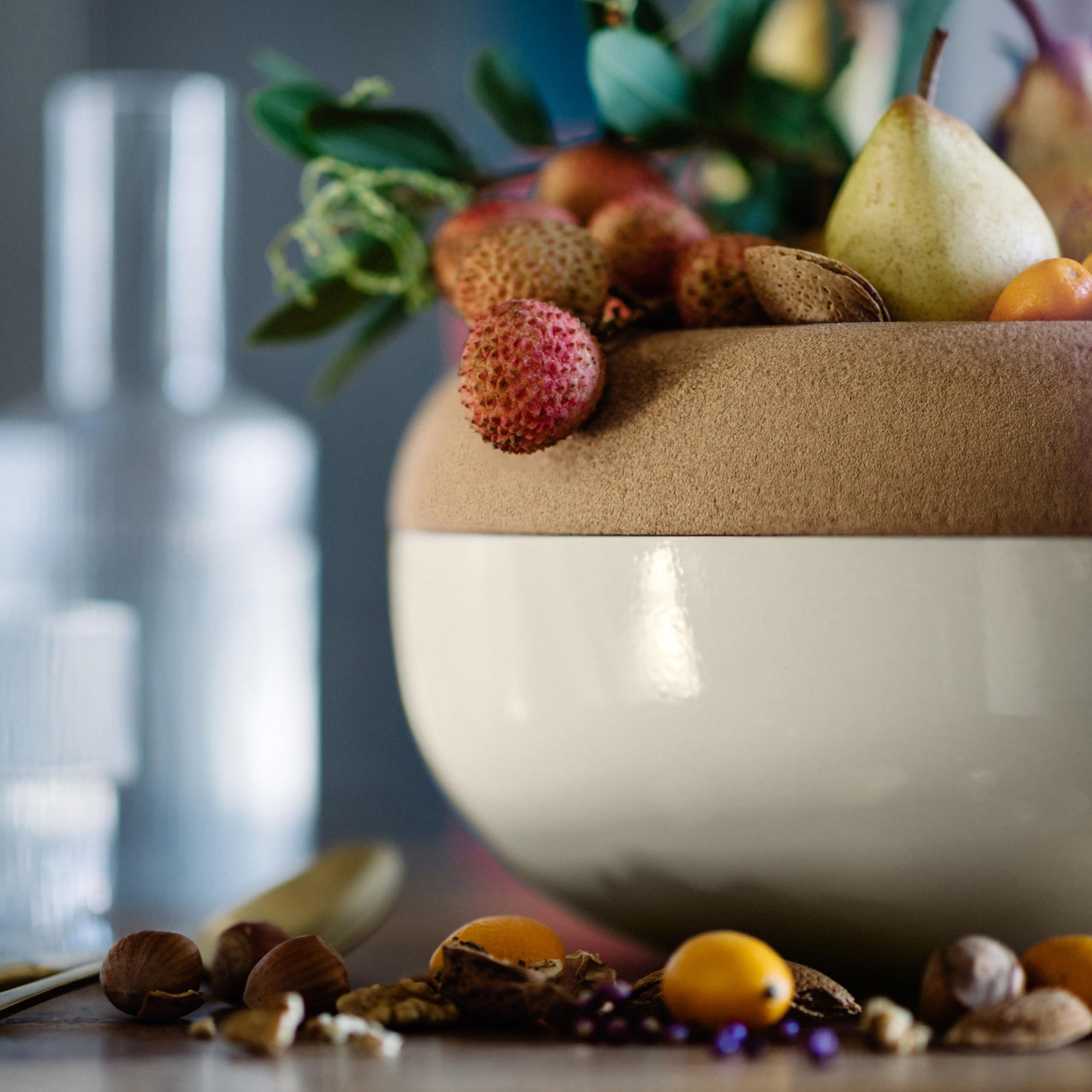 Emile Henry bowl in use with fruit above and potatoes below for organized storage
