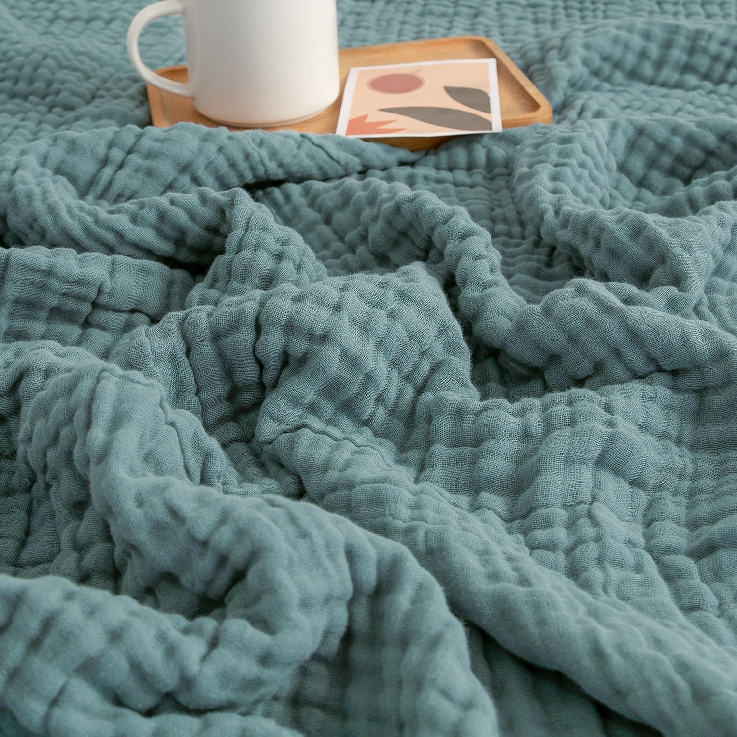 EMME front view of teal throw showing size and color benefits