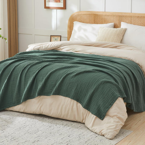 EMME throw layered on bed illustrating lightweight warmth and style
