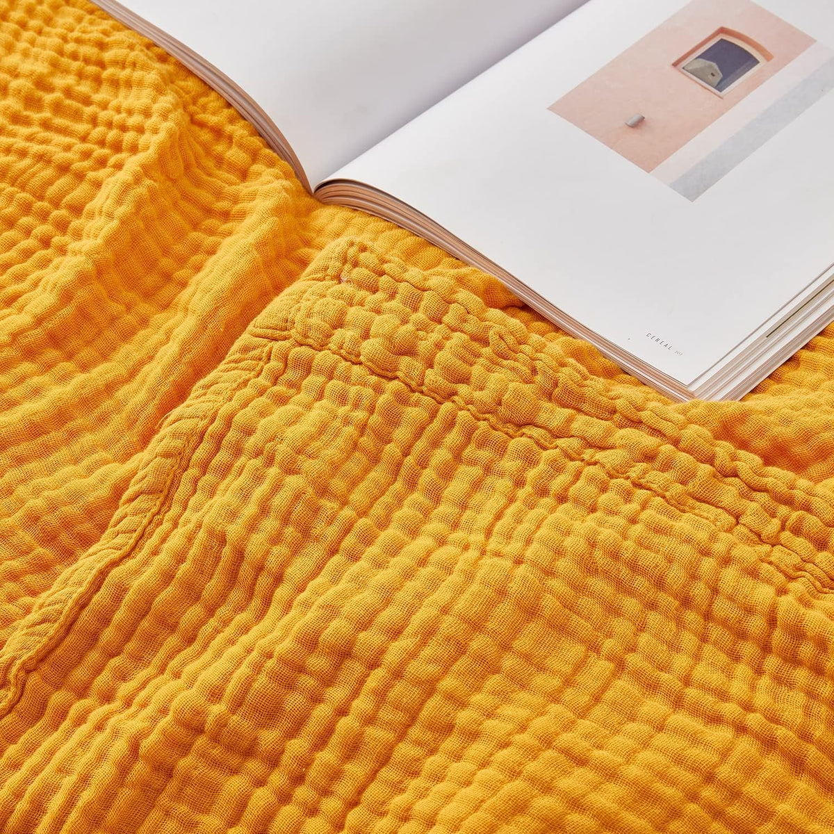 EMME muslin blanket front folded showing soft mustard color and cozy appeal