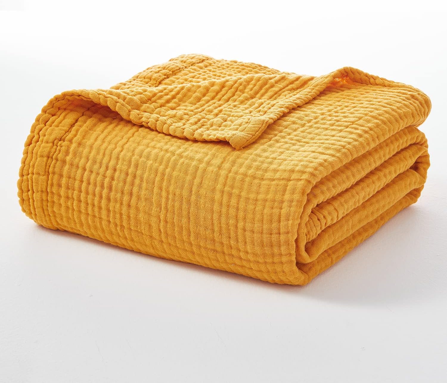 EMME blanket beside chair for size comparison showing generous 50x71 fit