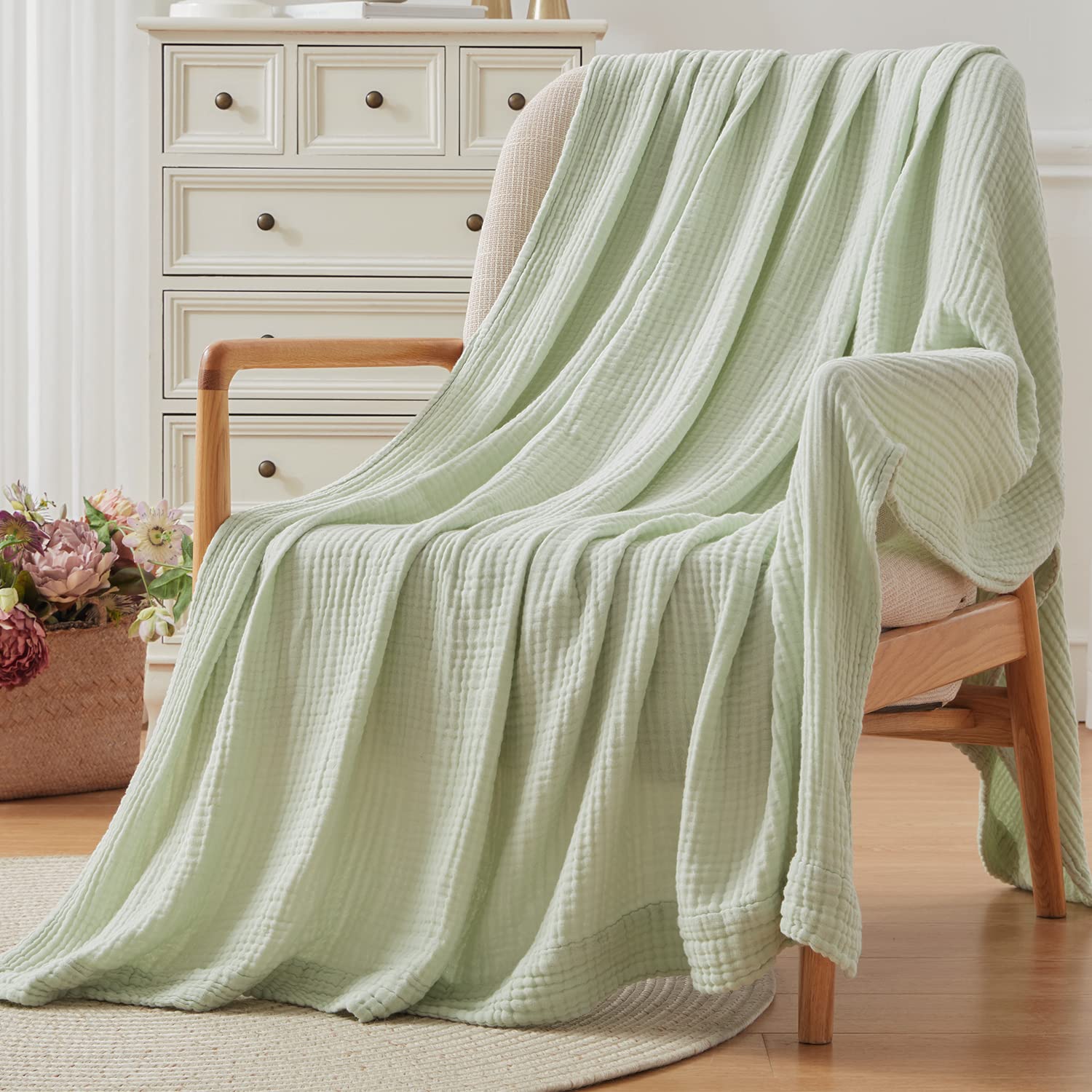 EMME throw draped on couch illustrating airy coverage and stylish mint accent