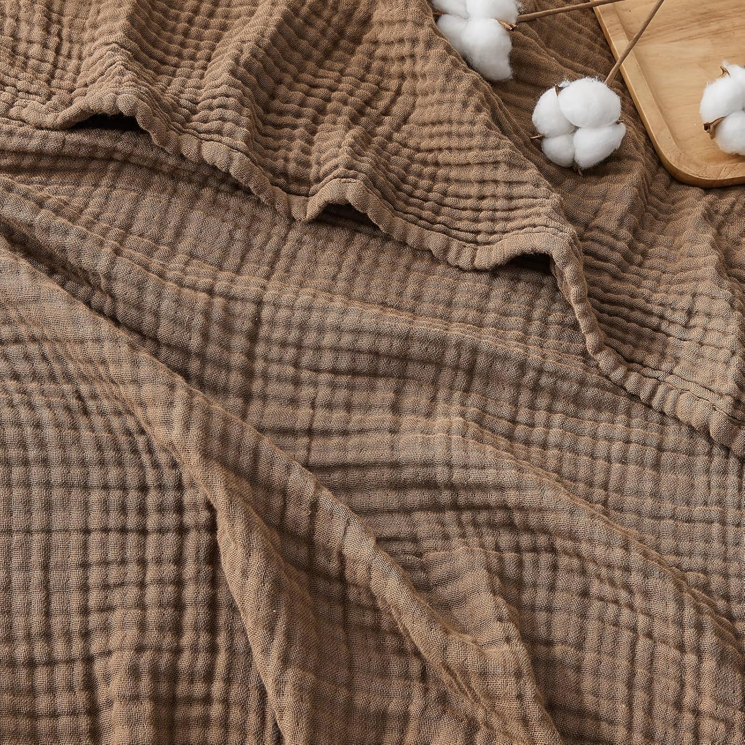 EMME folded throw on couch showing cozy neutral tone and instant decor upgrade