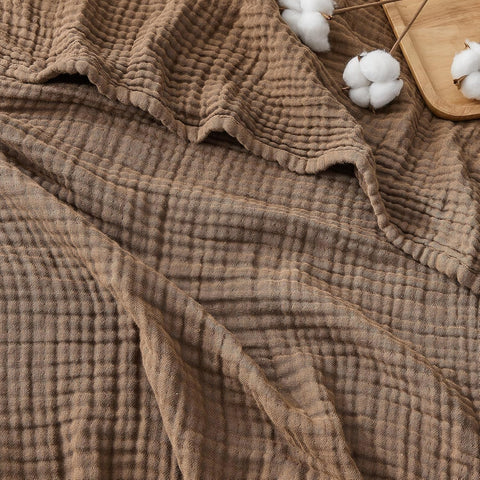 EMME folded throw on couch showing cozy neutral tone and instant decor upgrade