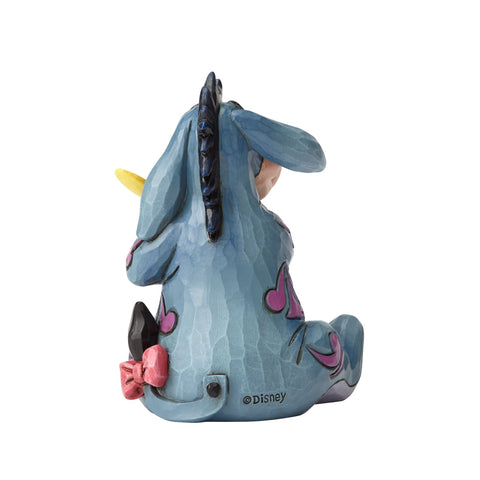 Enesco Eeyore with yellow butterfly accent adding cheerful contrast