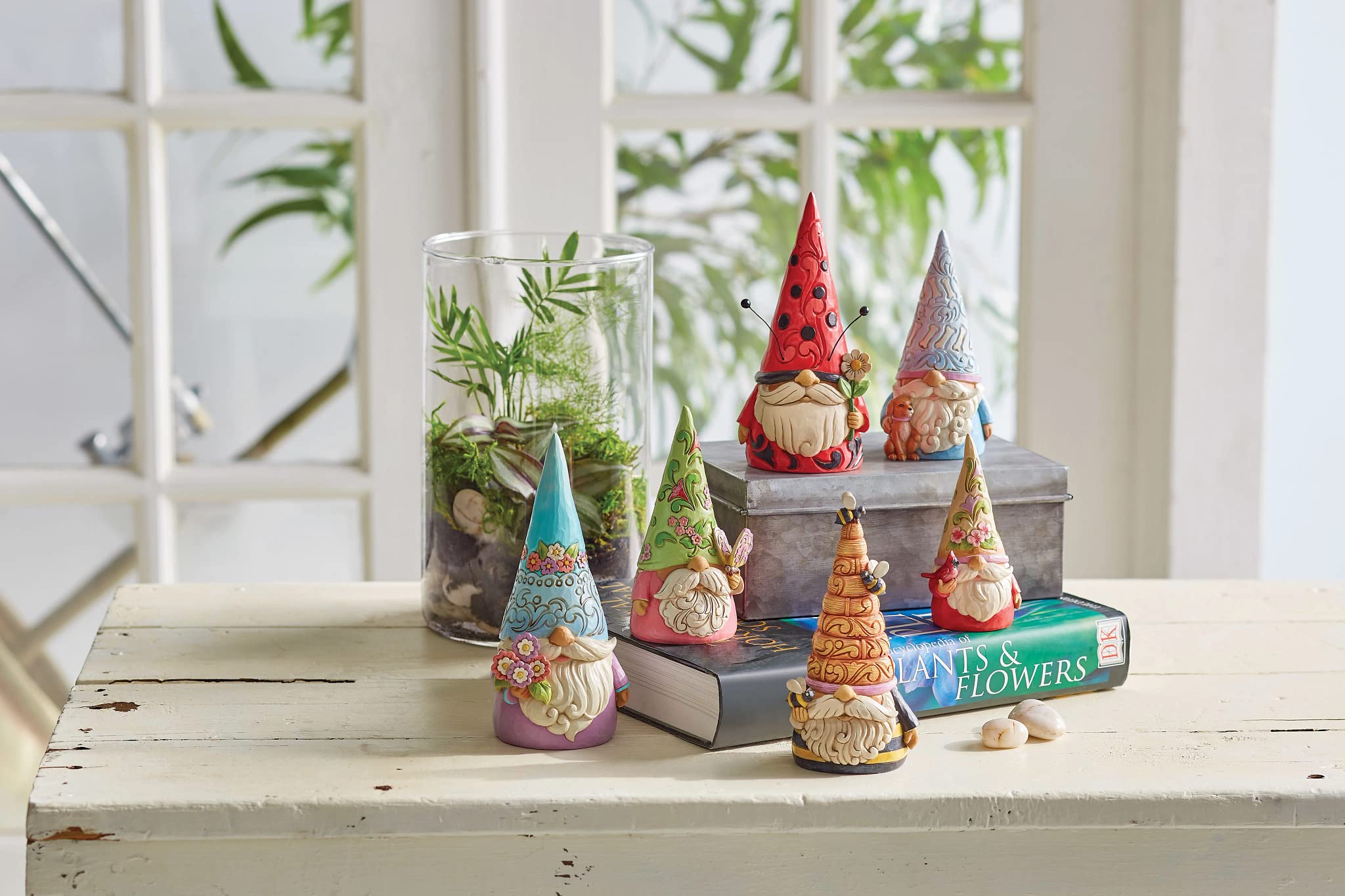 Enesco Jim Shore gnome next to book showing 6-inch scale and easy shelf placement benefit