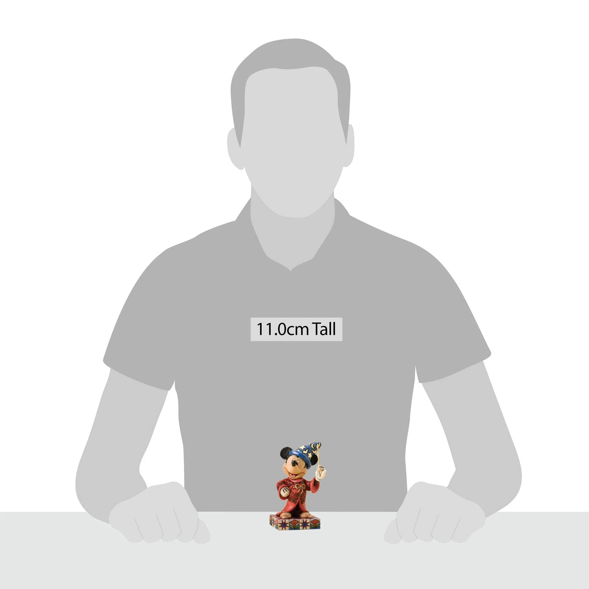 Enesco Sorcerer Mickey next to a book demonstrating compact scale