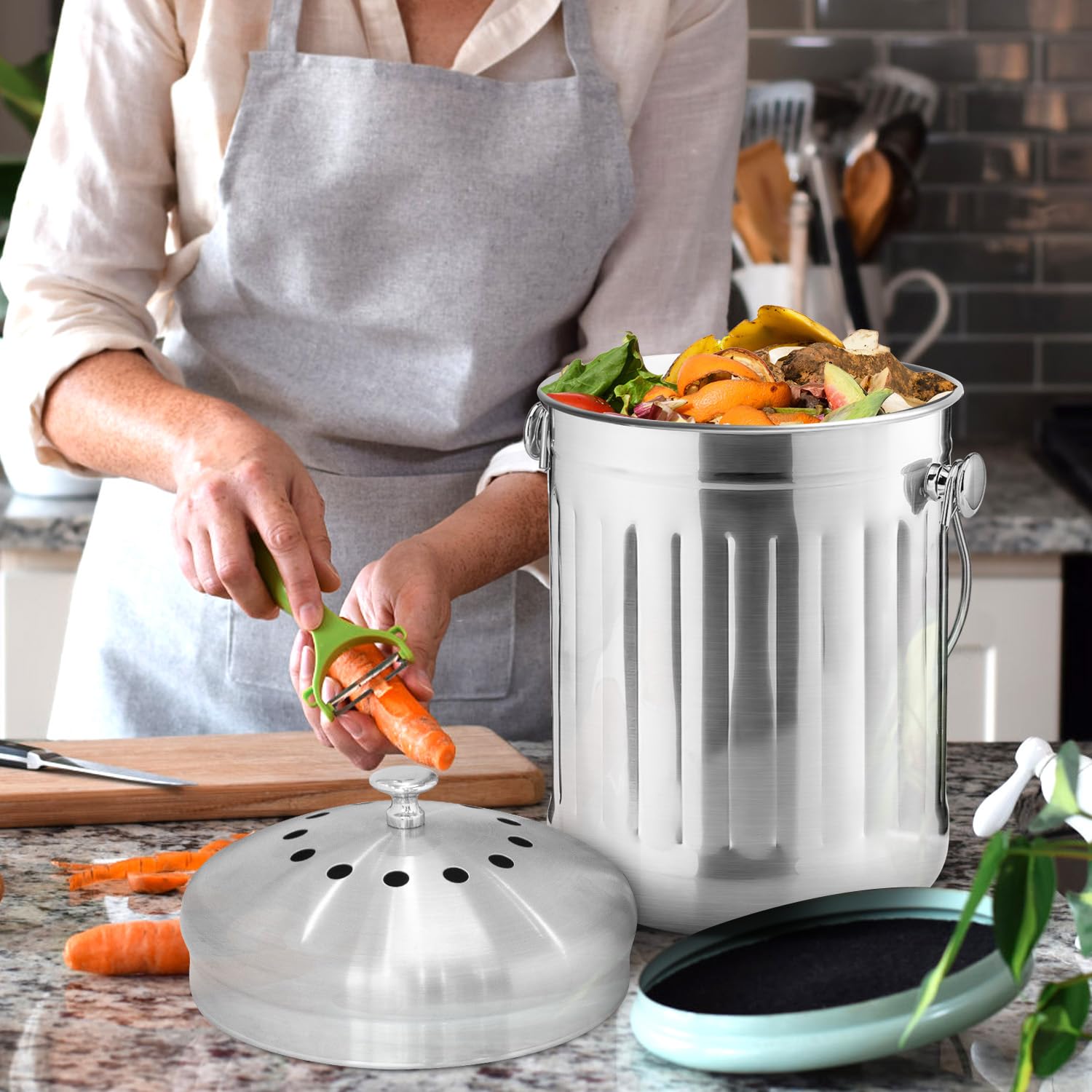 ENLOY being carried by its handle to outdoor compost showing convenient transfer benefit