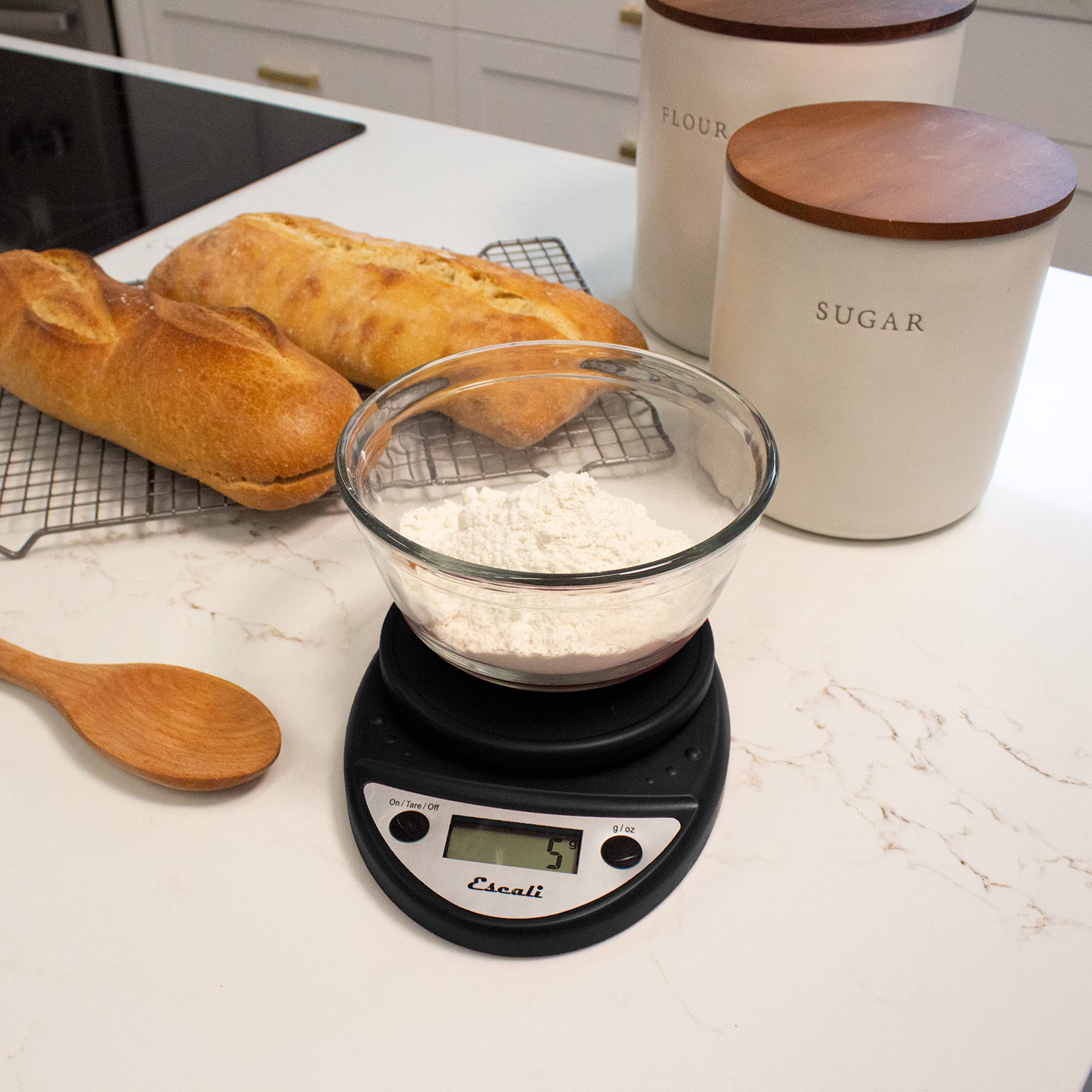 Escali Primo in use weighing flour in a mixing bowl for precise baking results