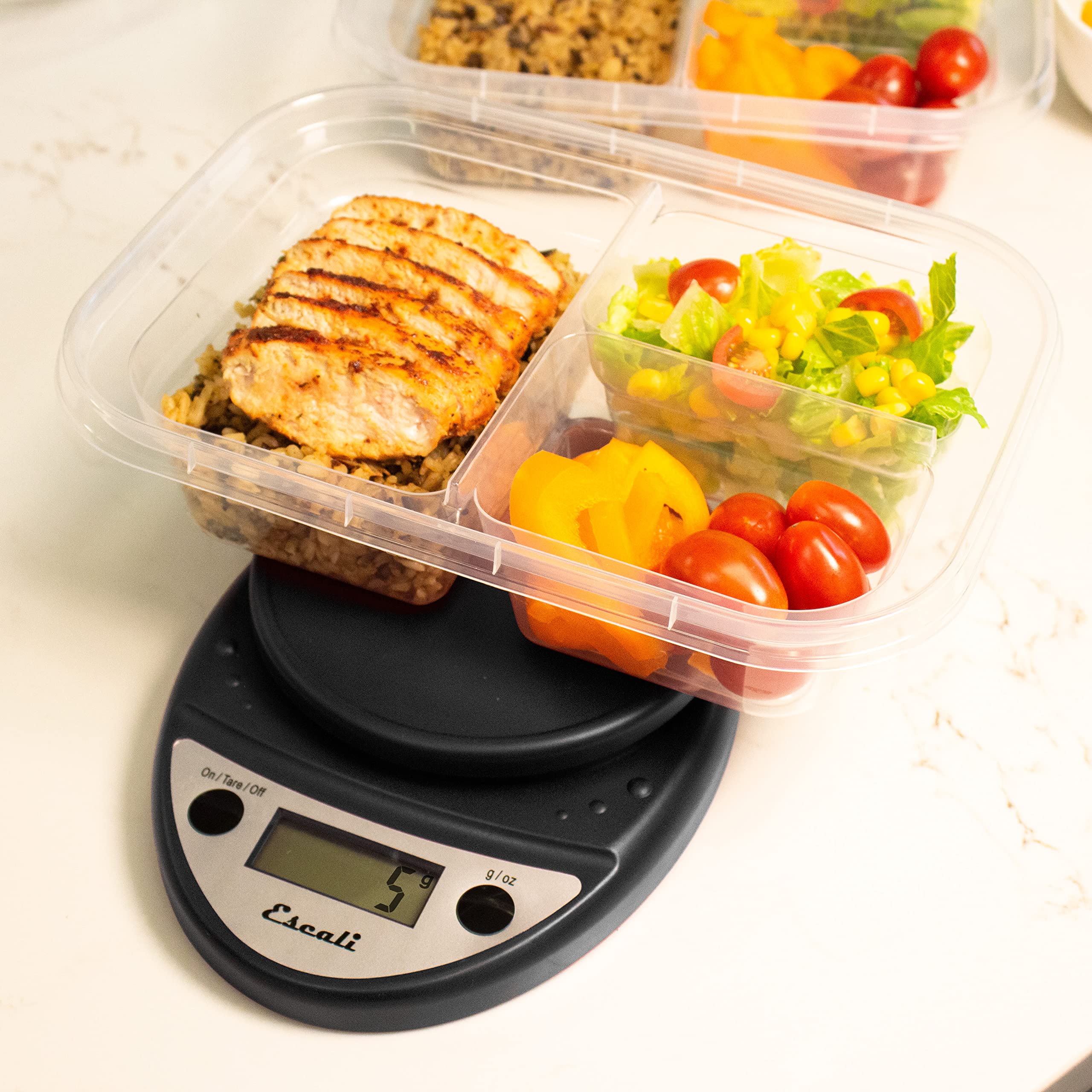 Escali Primo next to a spoon to show scale size and convenient countertop fit