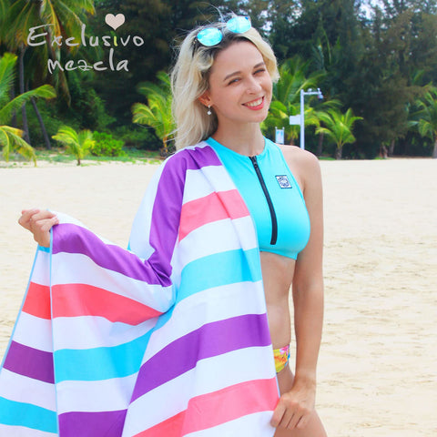 Exclusivo Mezcla towel folded into compact pouch for easy travel and storage