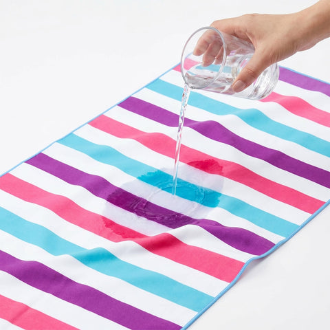 Exclusivo Mezcla towel next to person illustrating generous size and coverage benefit