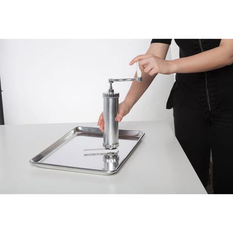 Fante's cookie press next to spatula showing scale and compact countertop footprint