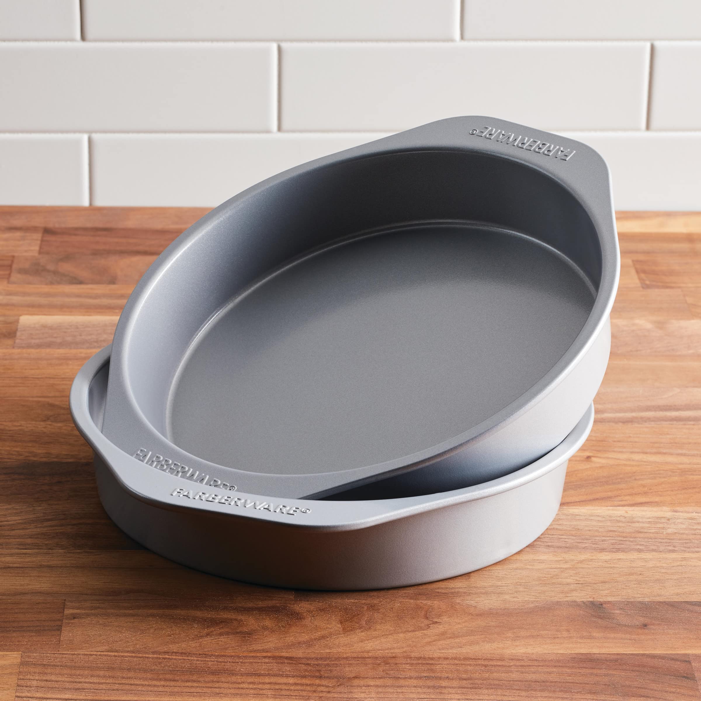 Farberware hand holding pan to illustrate lightweight feel and control