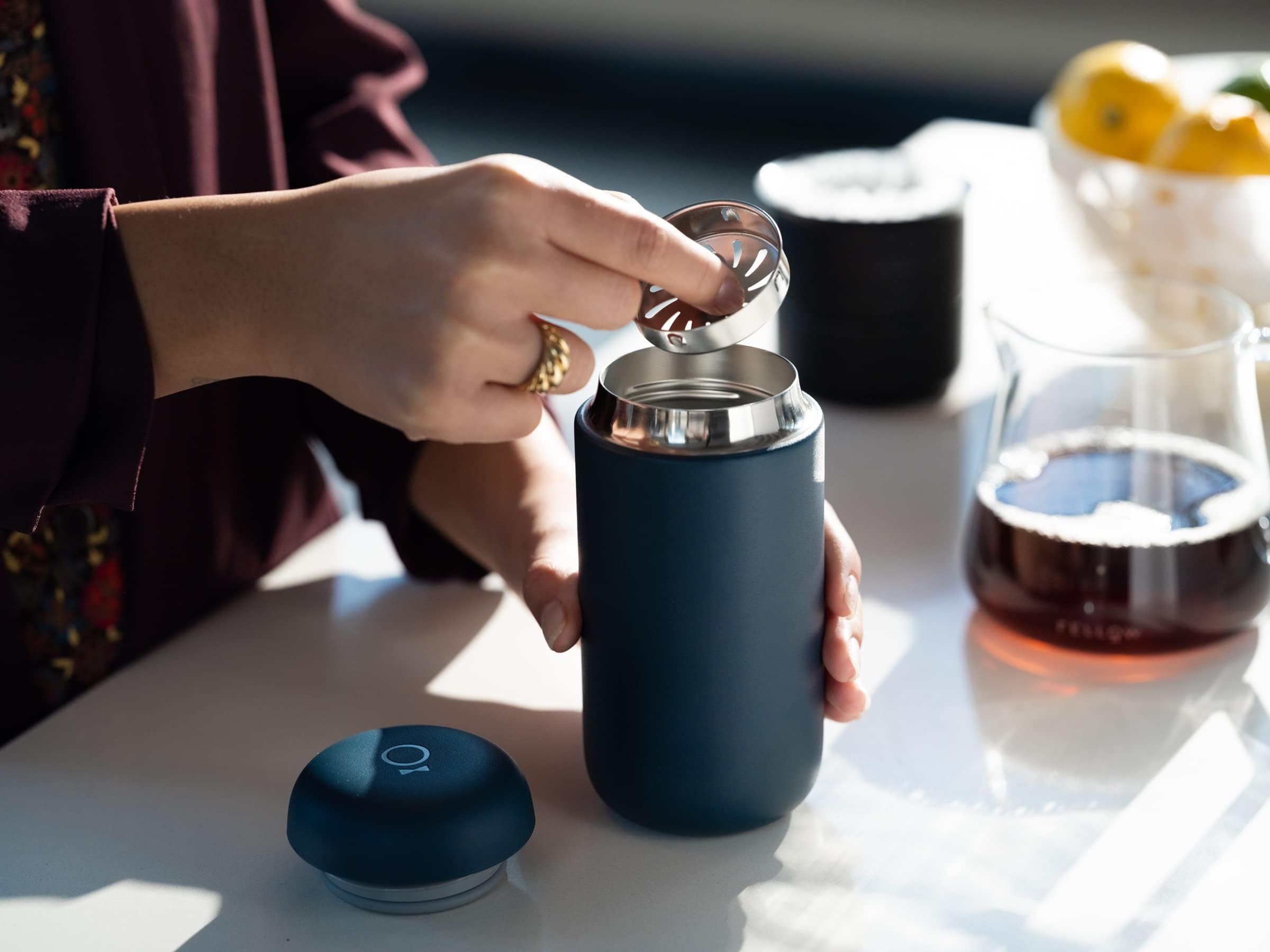 Fellow Carter Move on desk with notebook showing stylish reusable mug for daily routines