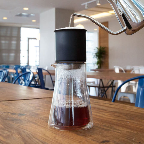 Fellow Stagg holding cold brew and cocktail illustrating versatile beverage use