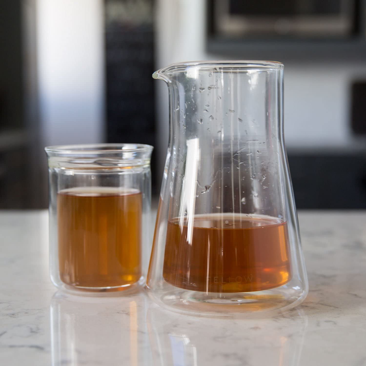 Fellow Stagg next to a scale and dripper illustrating 600ml scale and fit
