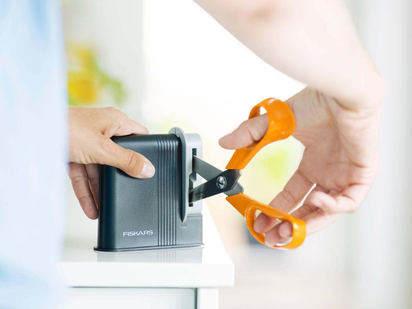 Fiskars Clip-Sharp used with scissors demonstrating quick resharpening benefit