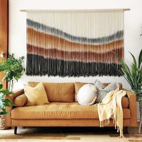 Flber front view of large macrame tapestry showing colors and shape, enhances room warmth