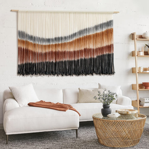 Flber displayed above bed as headboard alternative creating cozy boho bedroom