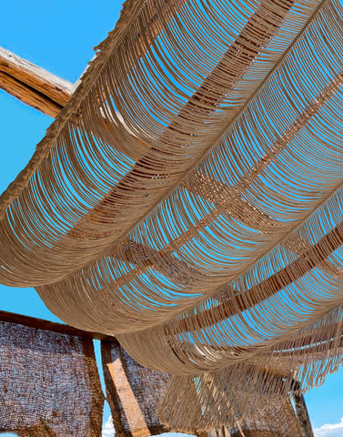 Flber macrame curtain hung at a window demonstrating diffused natural light