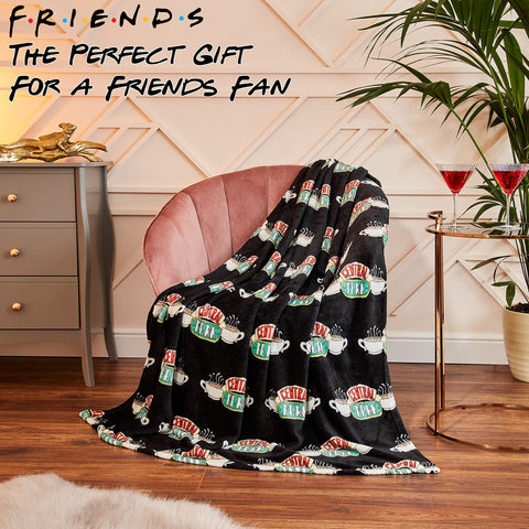 FRIENDS throw draped over chair showing scale and practical size benefit