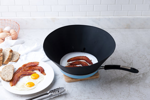Frywall in use with searing burger demonstrating reduced oil splatter
