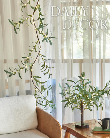 Fudios garland wrapped around banister adding cozy stair lighting