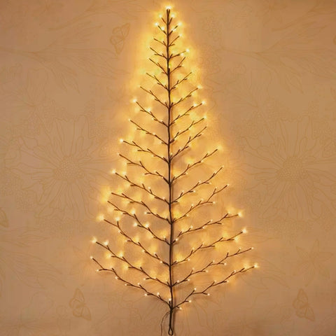 Fudios tree next to sofa showing scale and space-saving benefit