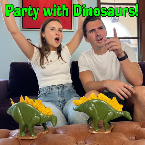 Funwares Nachosaurus with child placing chips, encouraging independent snacking and creativity