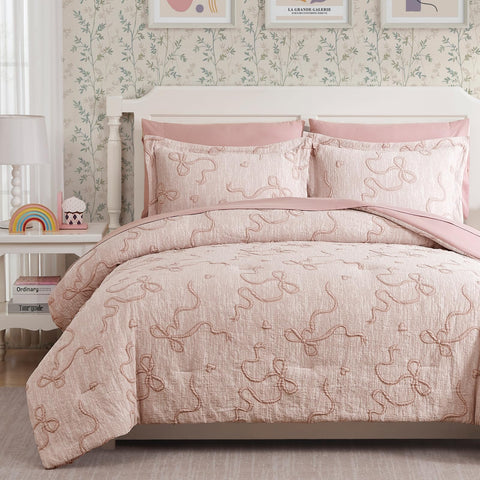 Geniospin front view full bed showing coordinated pink comforter and shams for instant styling