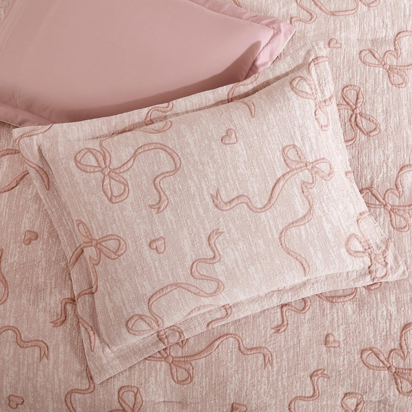 Geniospin styled bedroom angled shot showing elegant pink bedding creating a cozy retreat
