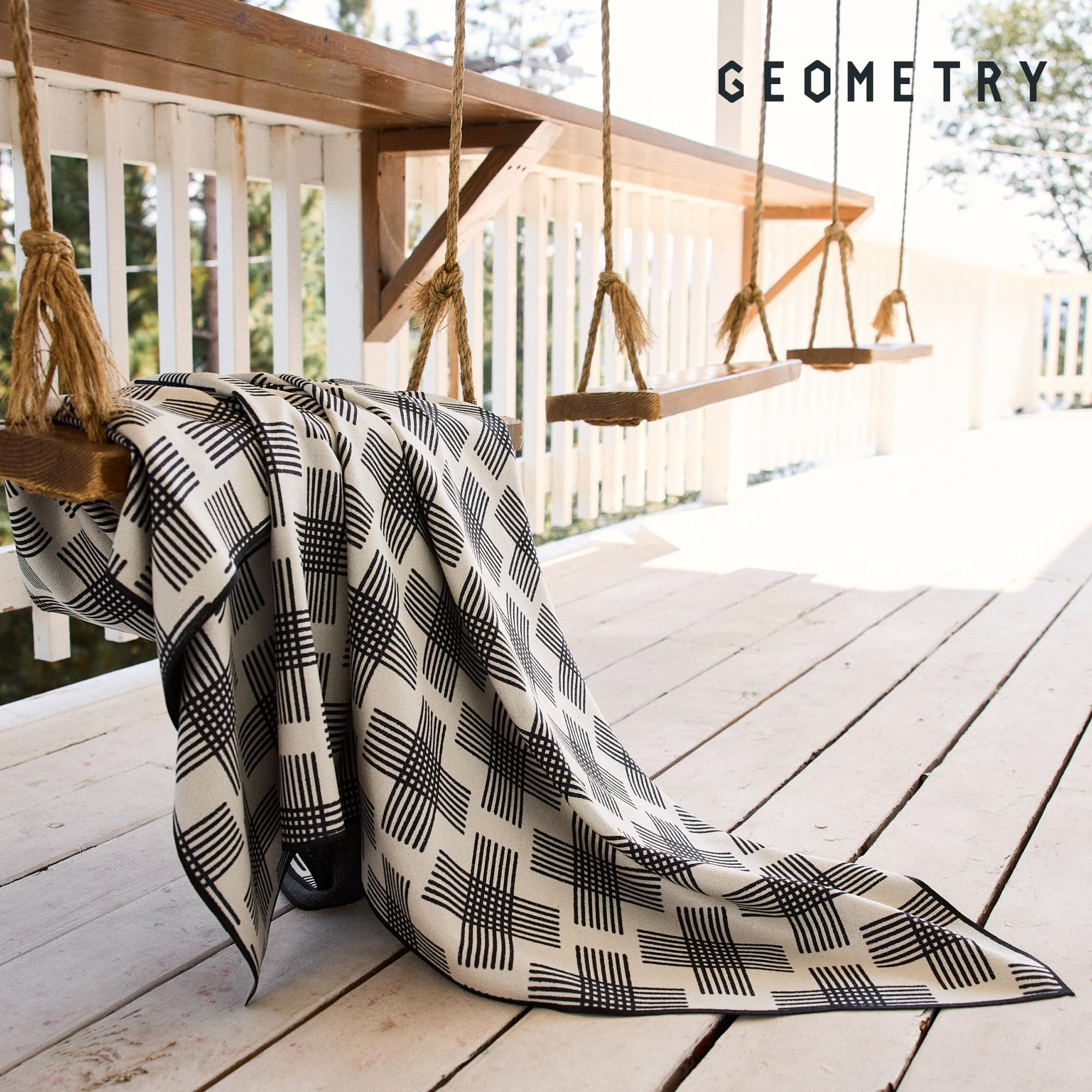 GEOMETRY towel spread on poolside lounge showing absorbency in use