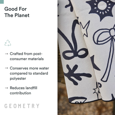 GEOMETRY towel on sand demonstrating sand-resistant fabric for easy cleanup