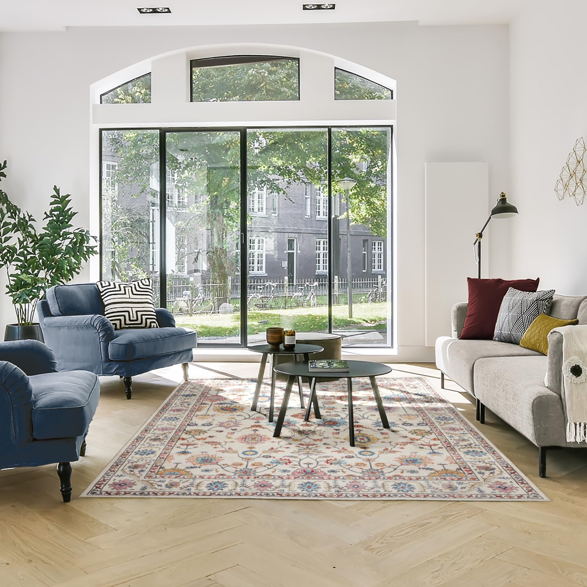 Gertmenian rug beside chairs showing 8x10 scale and how it anchors seating area