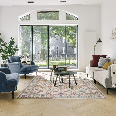 Gertmenian rug beside chairs showing 8x10 scale and how it anchors seating area