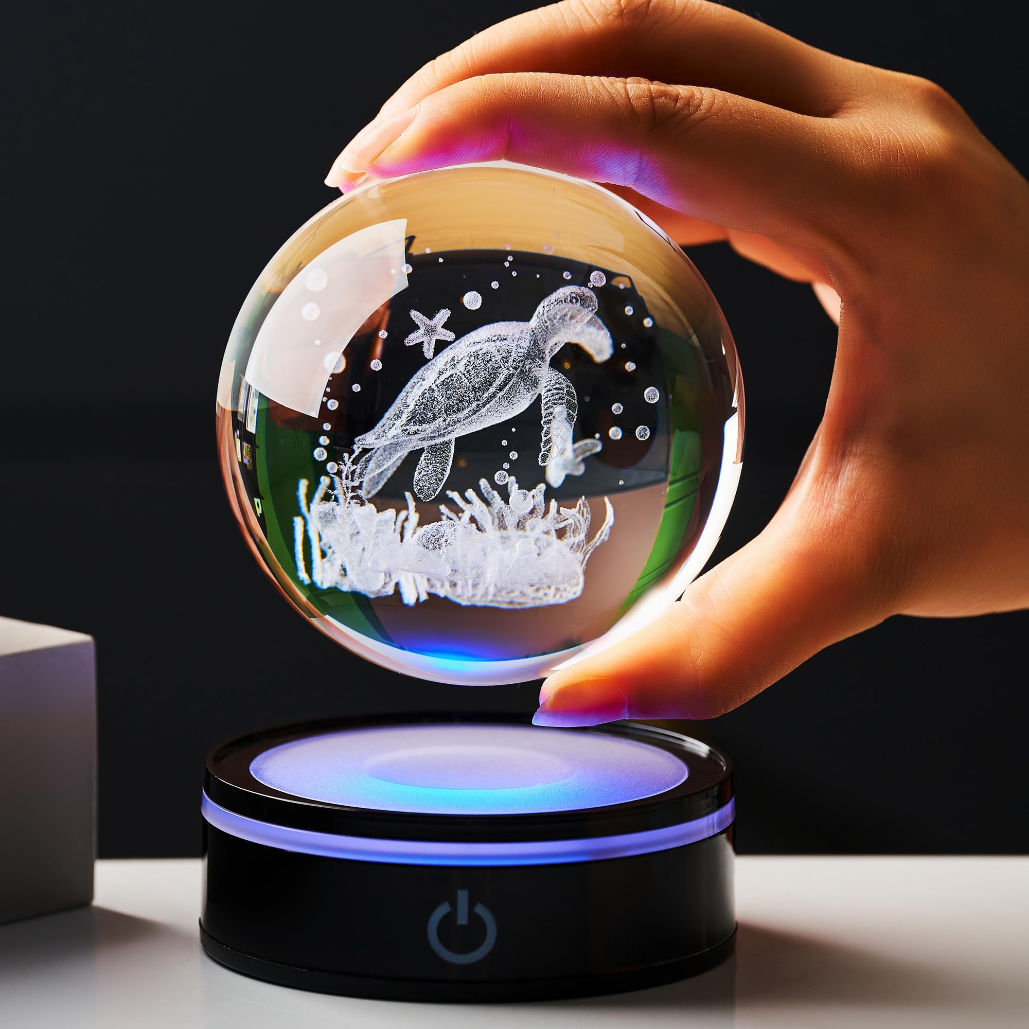 Ghtixsu crystal ball held in hand to show scale and portability benefit