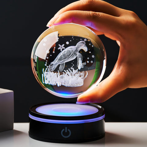 Ghtixsu crystal ball held in hand to show scale and portability benefit