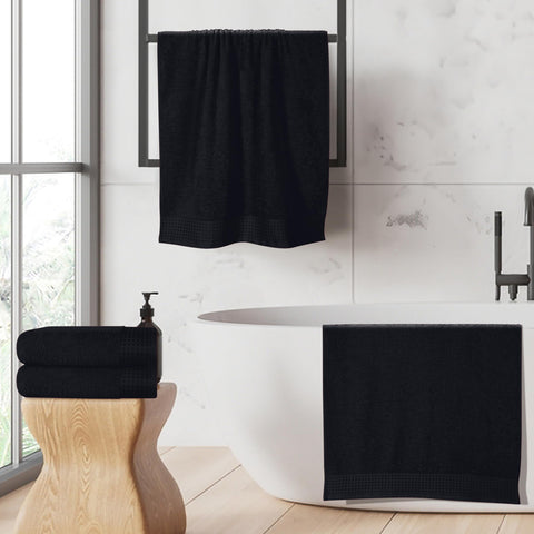 GLAMBURG towel draped poolside shows water absorption and sleek black color