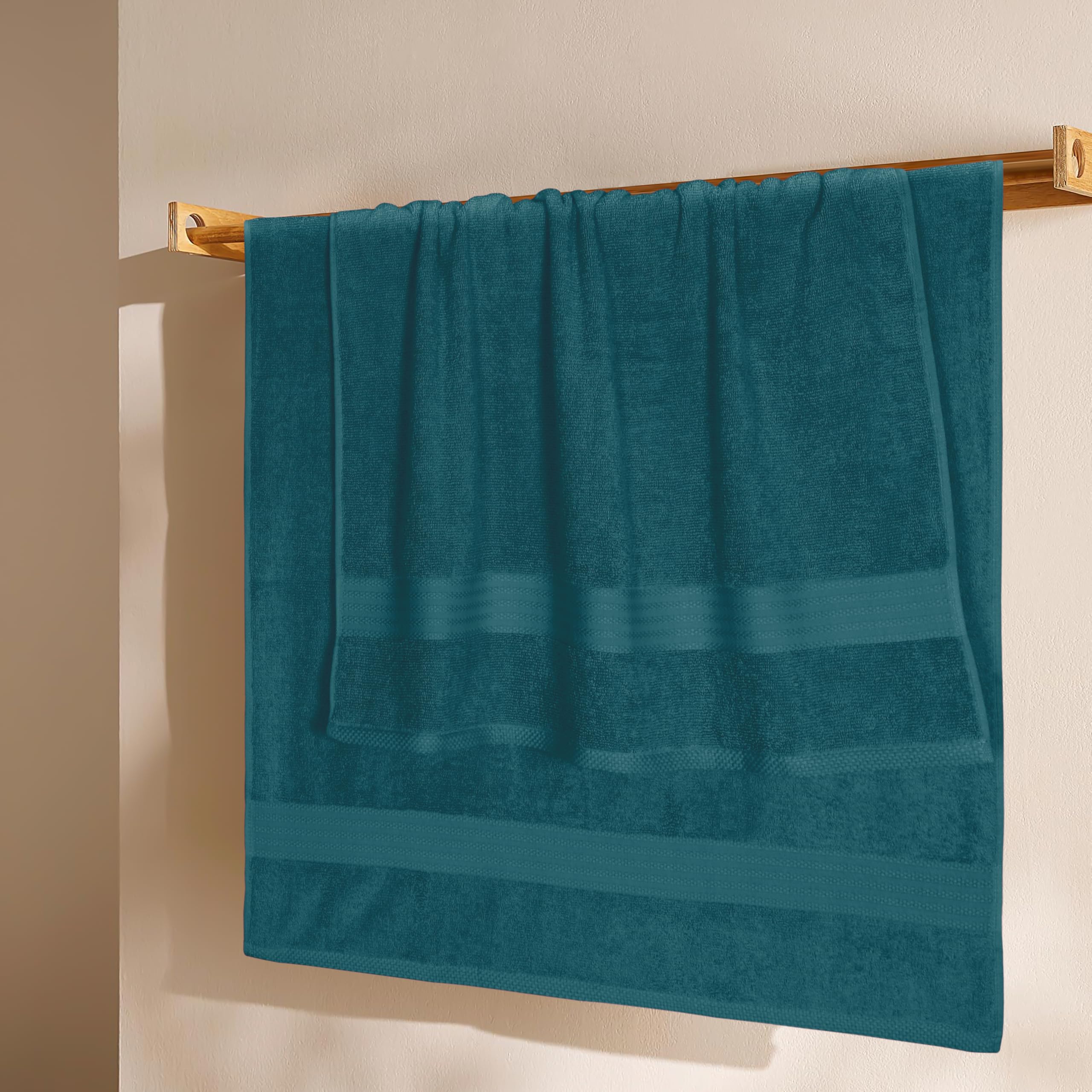GLAMBURG folded four towels stacked in bathroom highlighting neat storage