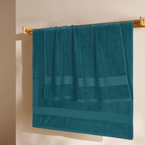 GLAMBURG folded four towels stacked in bathroom highlighting neat storage