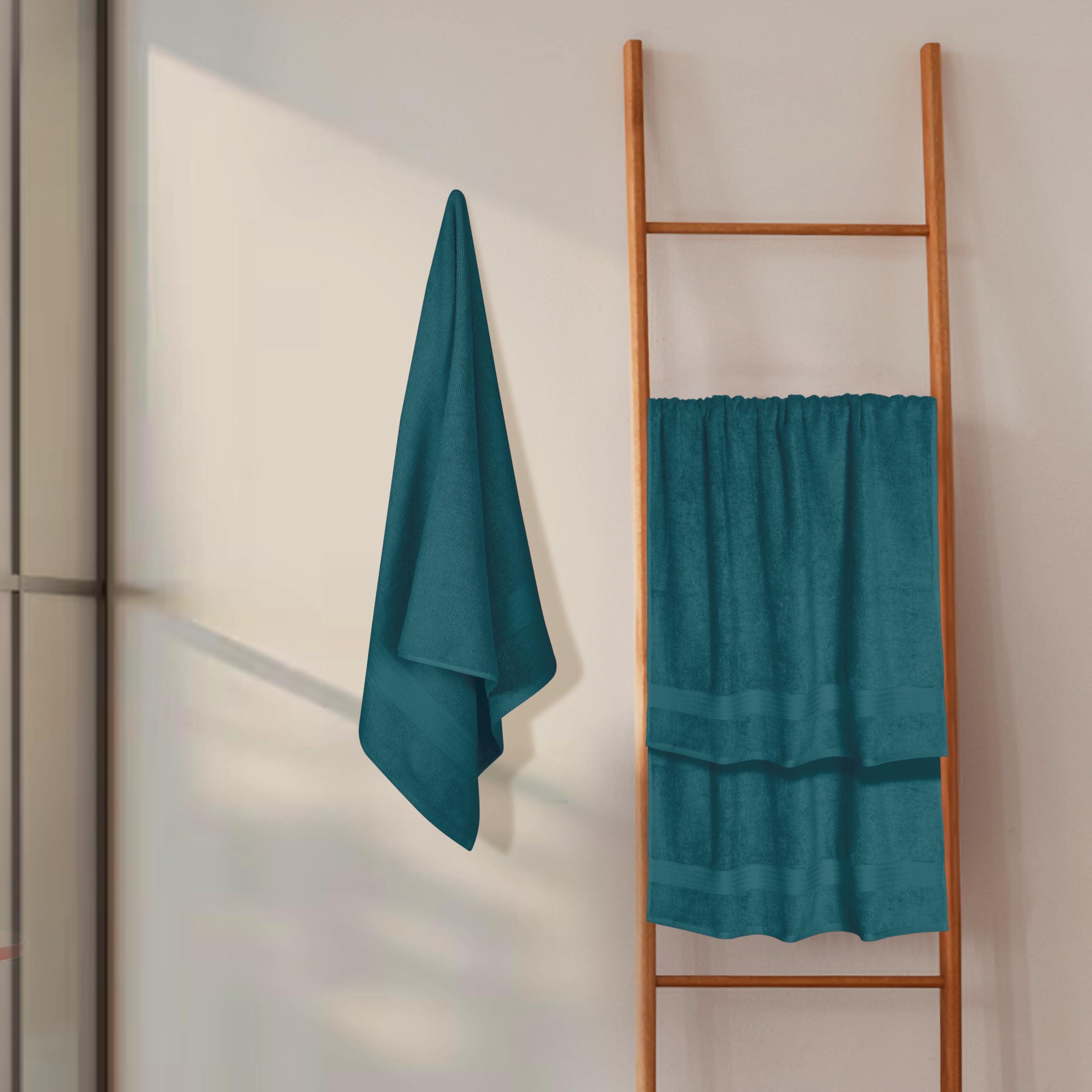 GLAMBURG towel held by person showing 27x54 size and full coverage