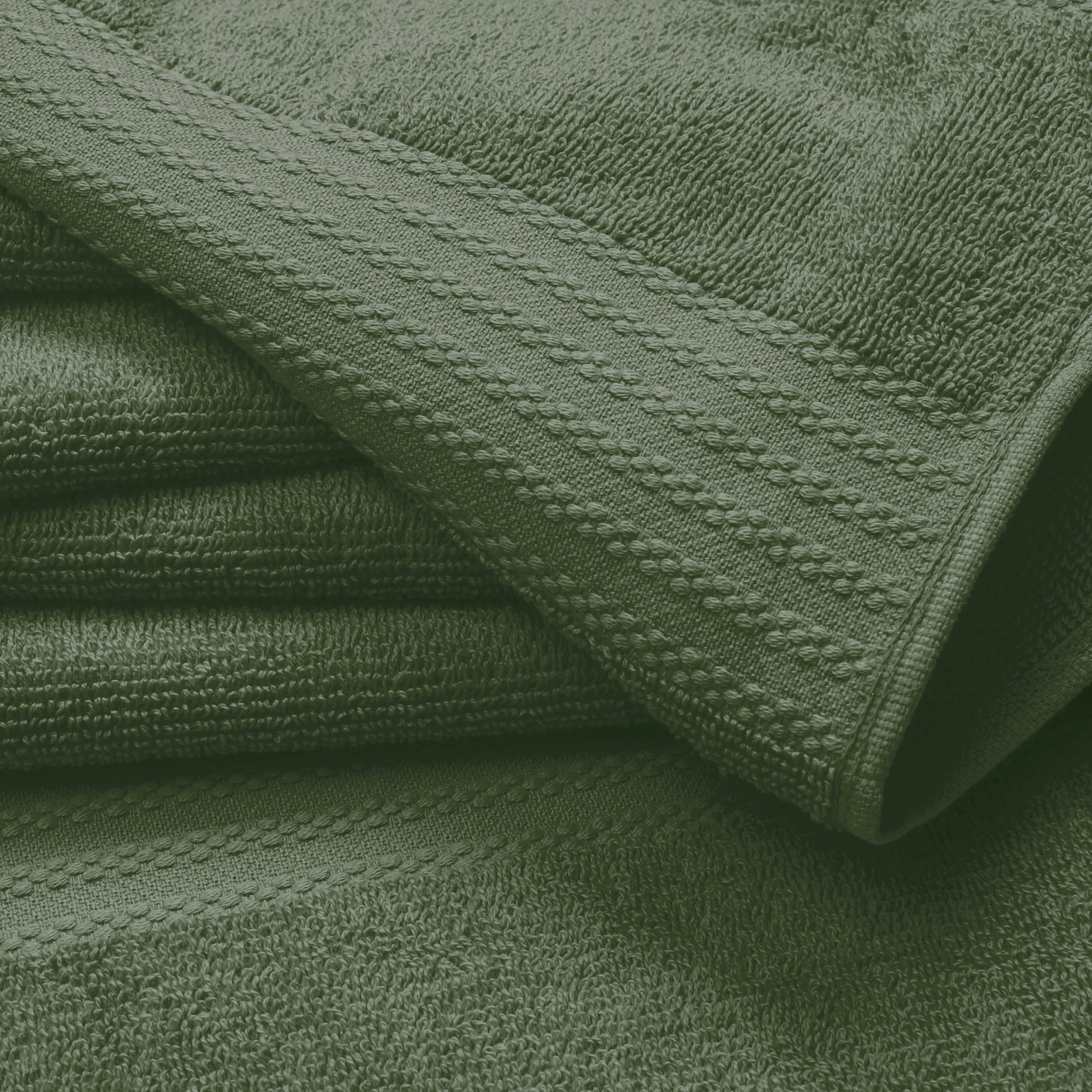 GLAMBURG close-up of oversized olive bath towel pile highlighting absorbent ring-spun cotton softness