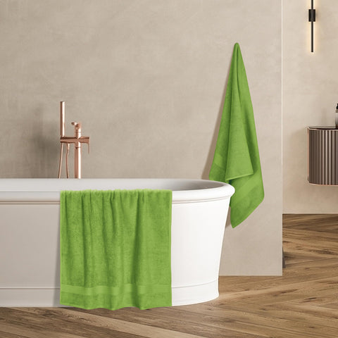 GLAMBURG towel next to common items showing 27x54 inch size for full coverage