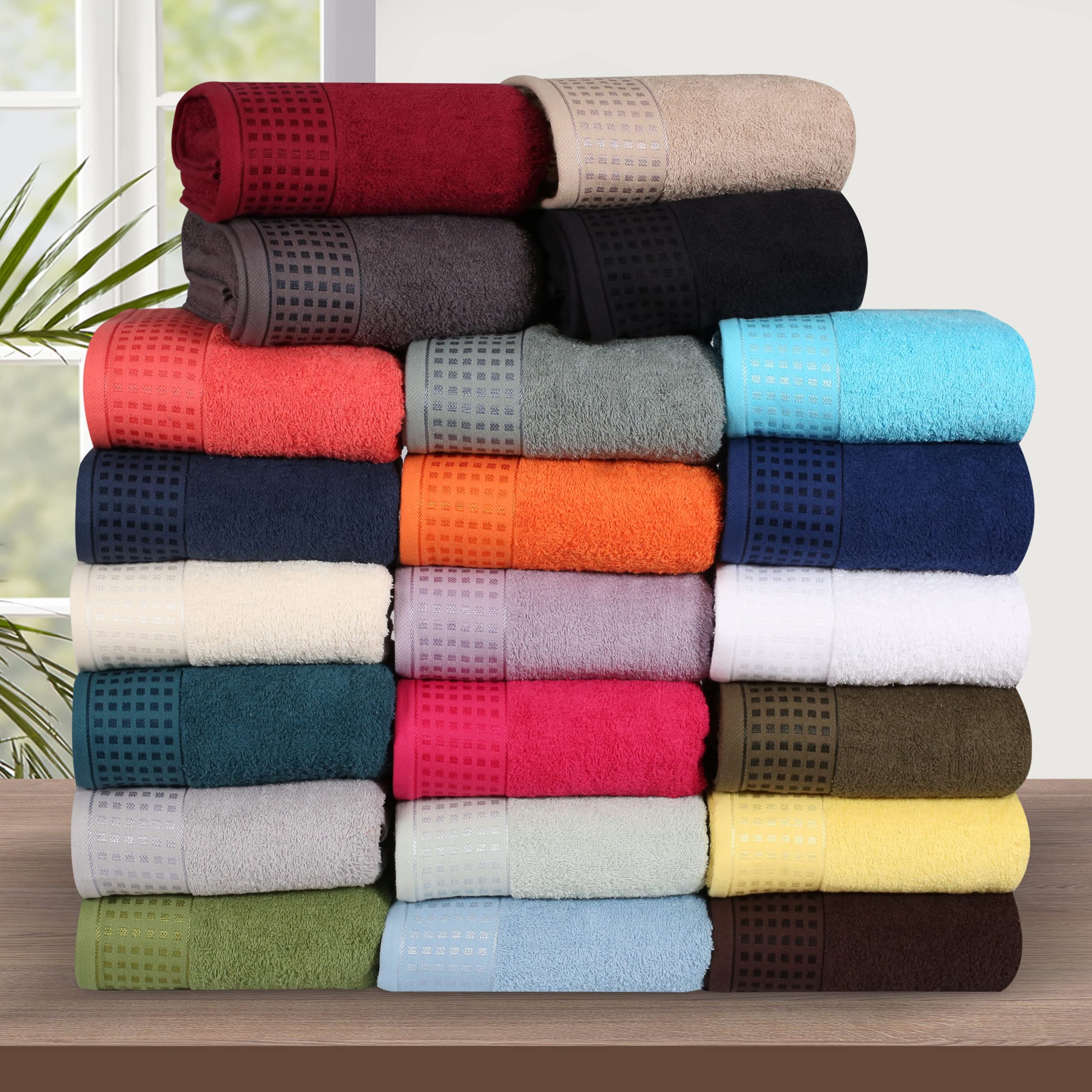 GLAMBURG towels beside ruler illustrating dimensions for packing and coverage