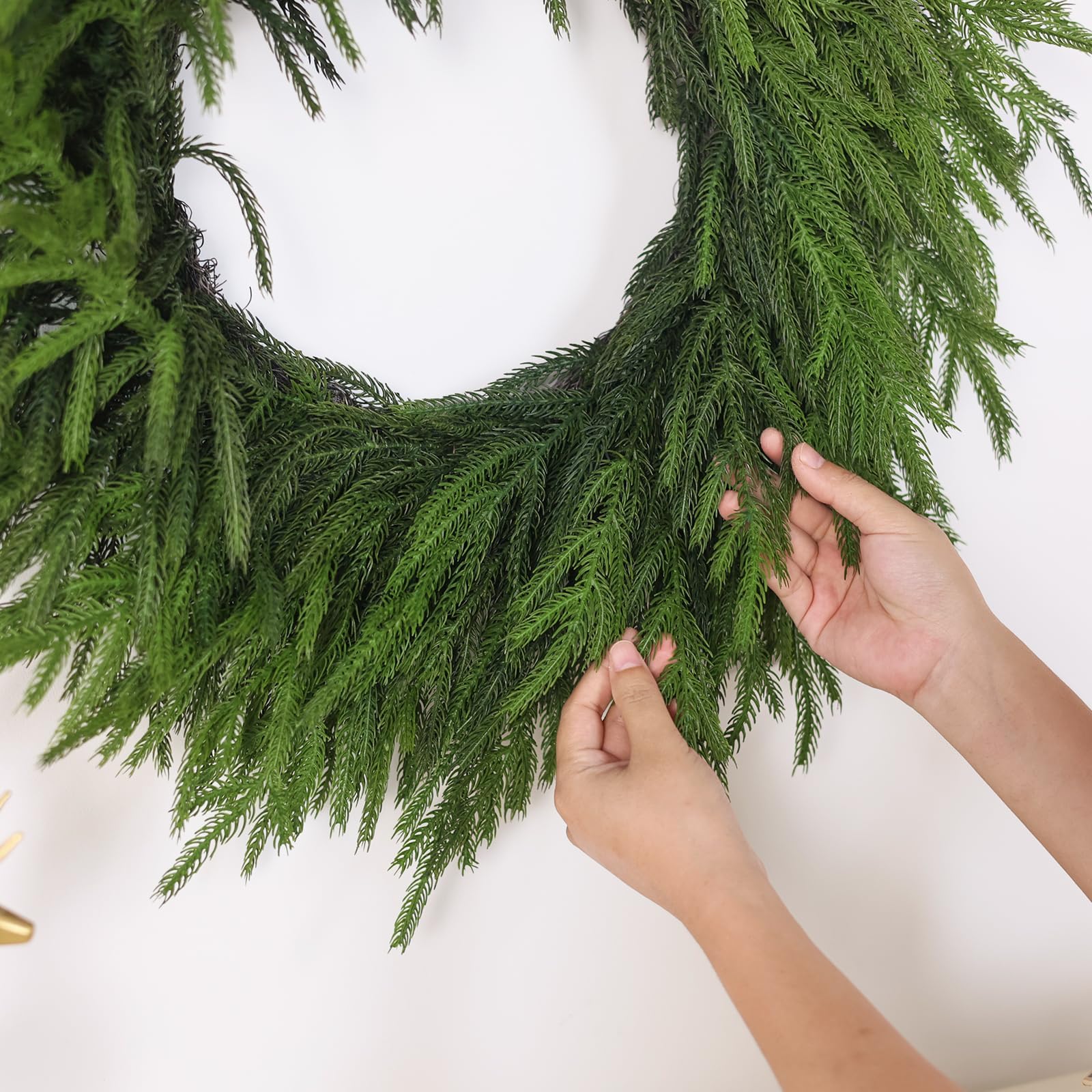GLIDLION unboxed wreath being fluffed to restore shape quickly